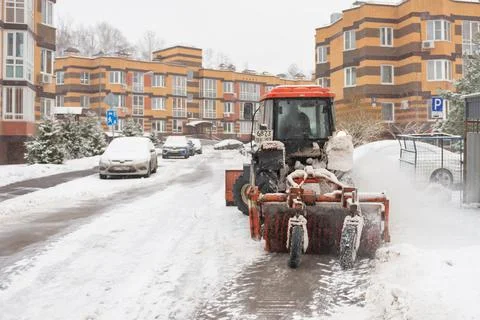 Tractor cleans the snow Stock Photos