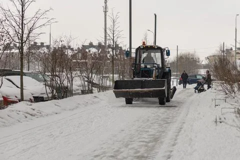 Tractor cleans the snow Stock Photos