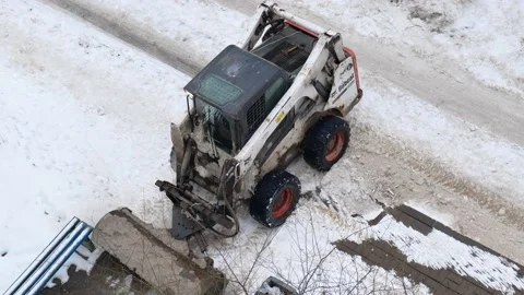 Tractor cleans the yard from snow Stock Footage 169742269