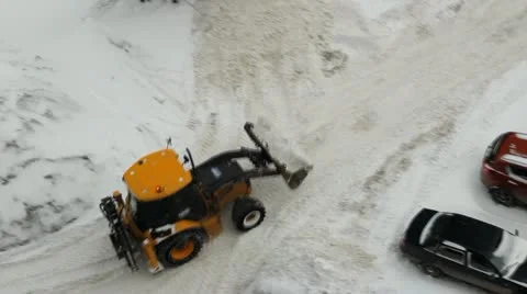 Tractor cleans the yard territory, parking Stockbeeldmateriaal 22261983