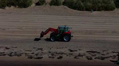 Tractor Clearing Sandy Beach During Coastal Maintenance, Aerial Stock Footage 344436050