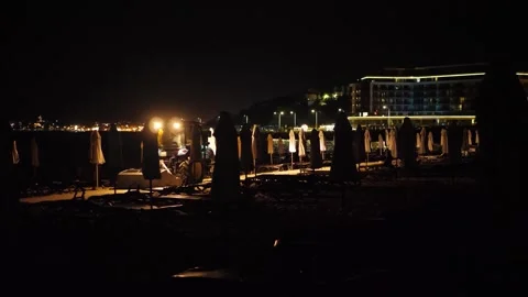 Tractor clears the seashore at night Stock Footage 336033650