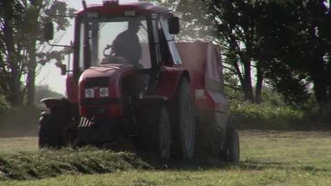 Tractor collecting grass in the field Stock Footage 85326882