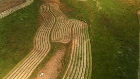 TRACTOR COLLECTING HAY VIA DRONE Stock Footage 249122234