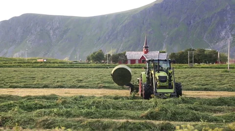 Tractor collecting hay Stock Footage 67674493