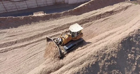 A tractor is collecting sawdust Stock Footage 74779386