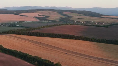 Tractor crossing a field in the evening Stock Footage 52509995
