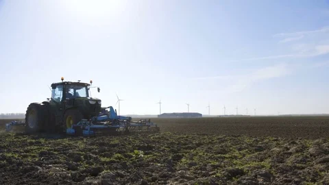 Tractor cultivating a field Stock Footage 70051167