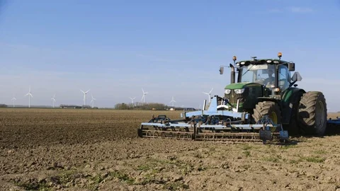 Tractor cultivating a field Stock Footage 70051577