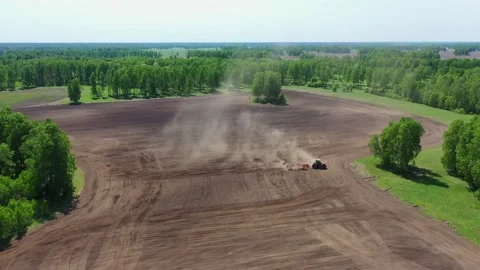 Tractor cultivating field at spring Stock Footage 130795875