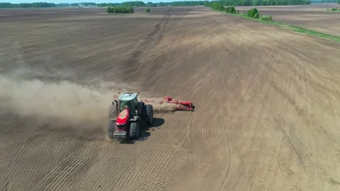 Tractor cultivating ground Stock Footage 130795868