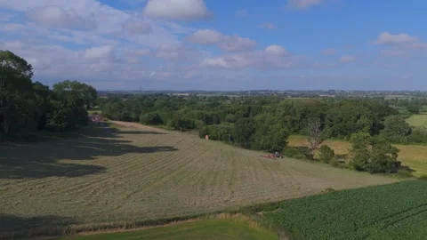 A tractor cutting grass, approaching the camera (drone shot) Stock Footage 312275893