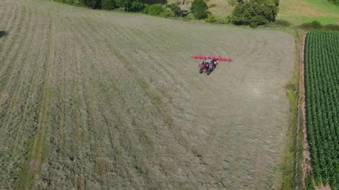 A tractor cutting grass, approaching the camera (drone shot) Stock Footage 312275941