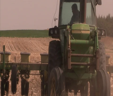 Tractor cutting wheat and chaff reverses direction Stock Footage 86748642