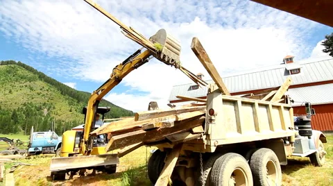 Tractor demolishing barn Stock Footage 1093764