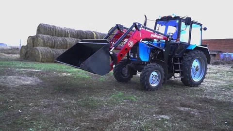 The tractor demonstrates its capabilities with a bucket. 3 Stock Footage 125228001