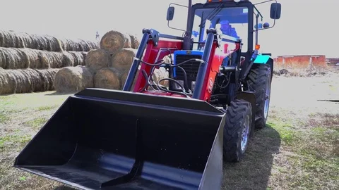 The tractor demonstrates its capabilities with a bucket. 4 Stock Footage 125228096
