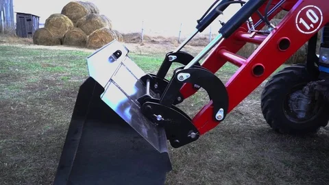 The tractor demonstrates its capabilities with a bucket. 7 Stock Footage 125228294