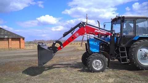 The tractor demonstrates its capabilities with a bucket. 8 Stock Footage 125228402