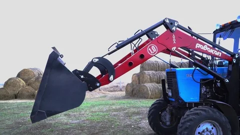 The tractor demonstrates its capabilities with a bucket 2 Stock Footage 125228449