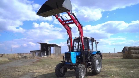 The tractor demonstrates its capabilities with a bucket.6 Stock Footage 125228200