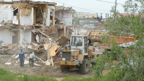 A tractor destroys an old house Stock Footage 165039660