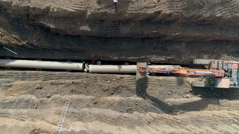 Tractor digging in sand soil ground to laying installing water pipeline Stock Footage 131012132