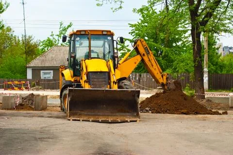 Tractor digging a trench Stock Photos