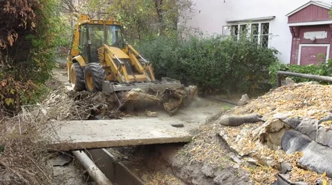 The tractor digs the earth pit with pipes Video stock 58644727