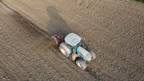 Tractor digs the soil to make water ditches works in the agricultural areas Vídeos de archivo 163809254