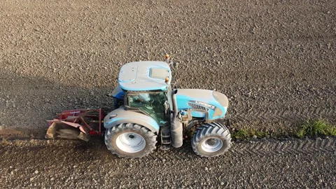 Tractor digs the soil to make water ditches works in the agricultural areas Vídeos de archivo 163810894