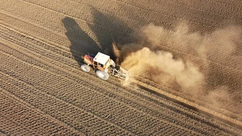 Tractor digs the soil to make water ditches works in the agricultural areas Stock Footage 164027886