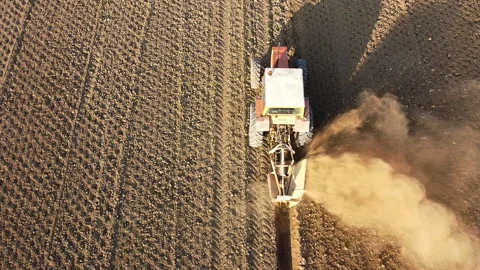 Tractor digs the soil to make water ditches works in the agricultural areas Stock Footage 164028514