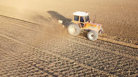 Tractor digs the soil to make water ditches works in the agricultural areas Stock Footage 164028813