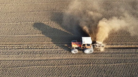 Tractor digs the soil to make water ditches works in the agricultural areas Vídeo Stock 164028919