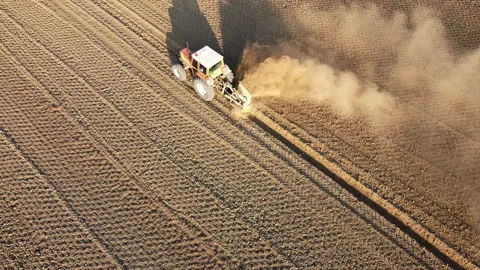 Tractor digs the soil to make water ditches works in the agricultural areas Stock-Footage 164029278