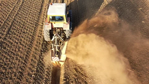 Tractor digs the soil to make water ditches works in the agricultural areas Stock-Footage 164029409