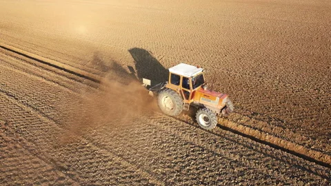 Tractor digs the soil to make water ditches works in the agricultural areas Stock Footage 164030161