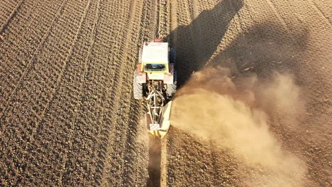 Tractor digs the soil to make water ditches works in the agricultural areas Video stock 164030406