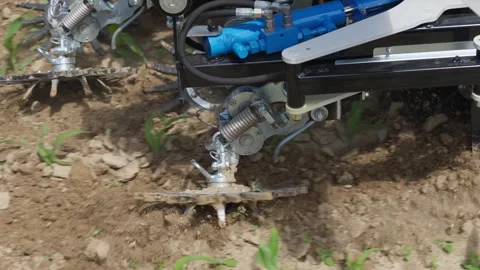 A tractor is in the dirt with a piece of equipment attached to it Stock Footage 296100267