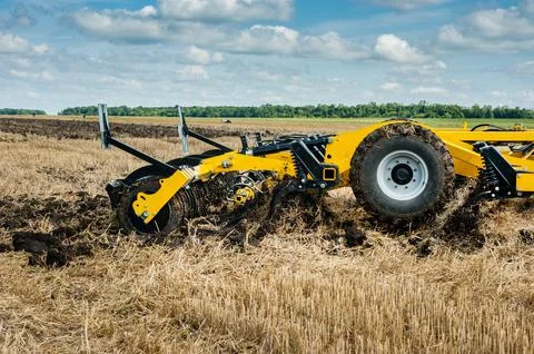Tractor with a disc cultivator, a system for processing soil in at work Stock Photos