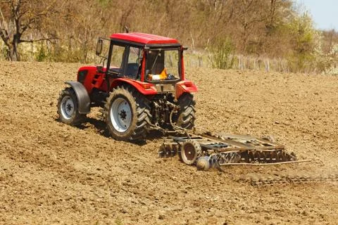Tractor with disk harrow and rake Stock Photos