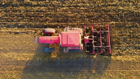 Tractor with disk harrow system plowing soil ground on cultivated farm field Video stock 209512750