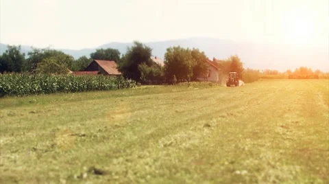 Tractor in distance working on the meadow Stock Footage 10575570