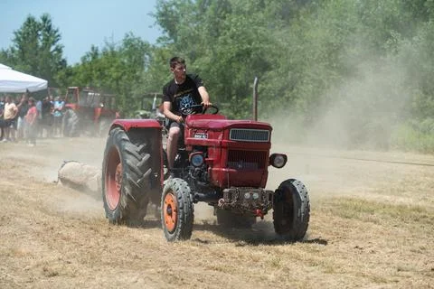 Tractor do wheelie while pulling log Stock Photos