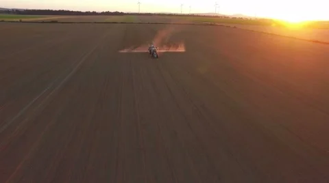 Tractor doing field sprayer at sunset Stock Footage 67232296