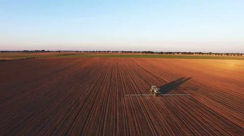 Tractor doing field sprayer at sunset Stock Footage 67232312
