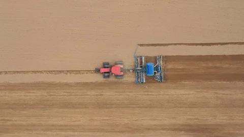 Tractor Drill Plows And Seeder Plants Seeds Of Grain Crops In Agricultural Field Stock Footage 122452148