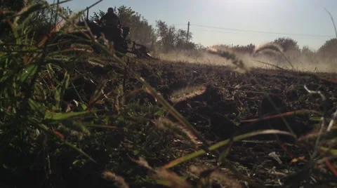 Tractor driver plows a field in summer Stock Footage 68387605