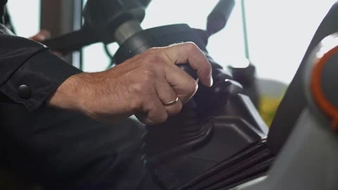 Tractor driver shifting gearbox lever and preparing steering wheel for steering Video stock 270060893